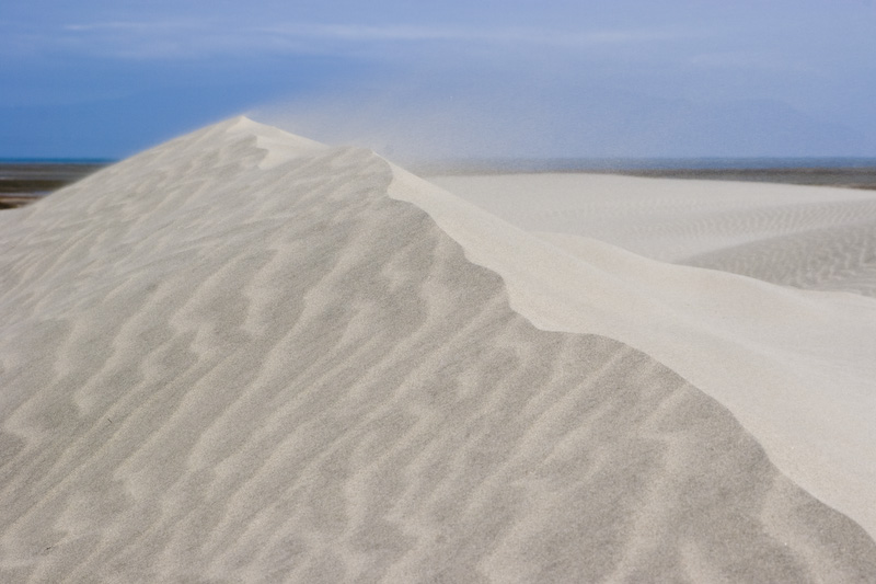 Wind Blowing Sand Over Crest Of Dune